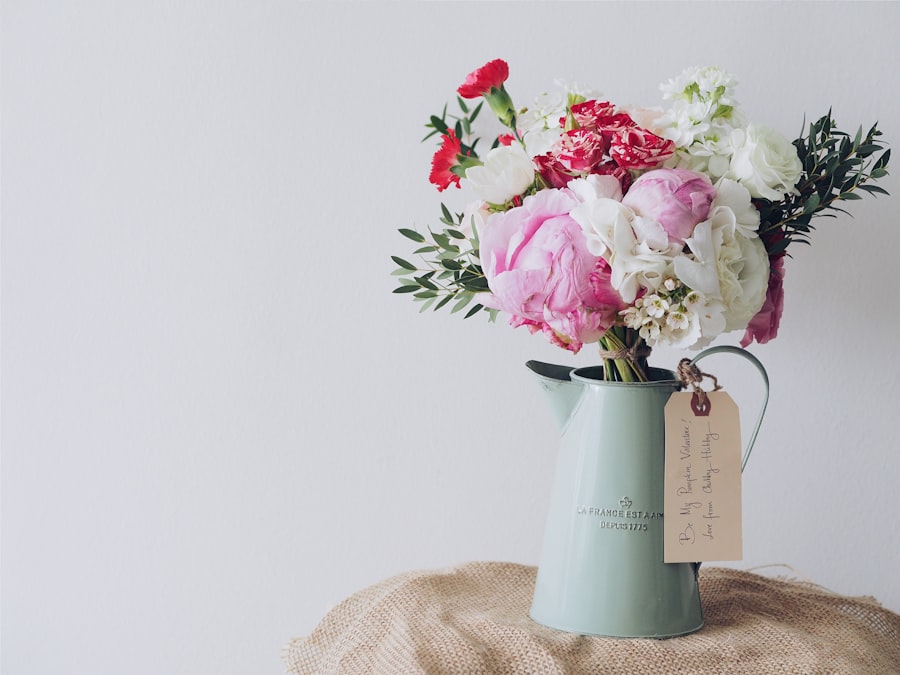 Cottage-style arrangement of peonies and carnations in a sage-green jug