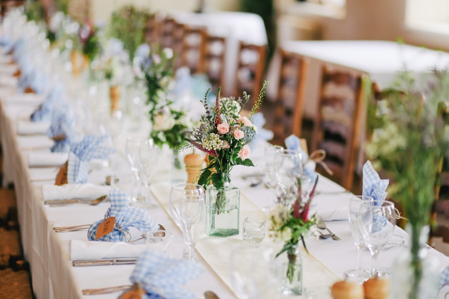 Long wedding table dressed with jars of wildflower posies